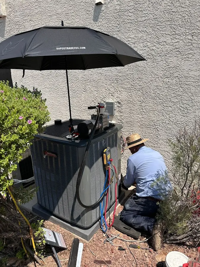 HVAC technician performing outdoor AC maintenance in Port Orange
